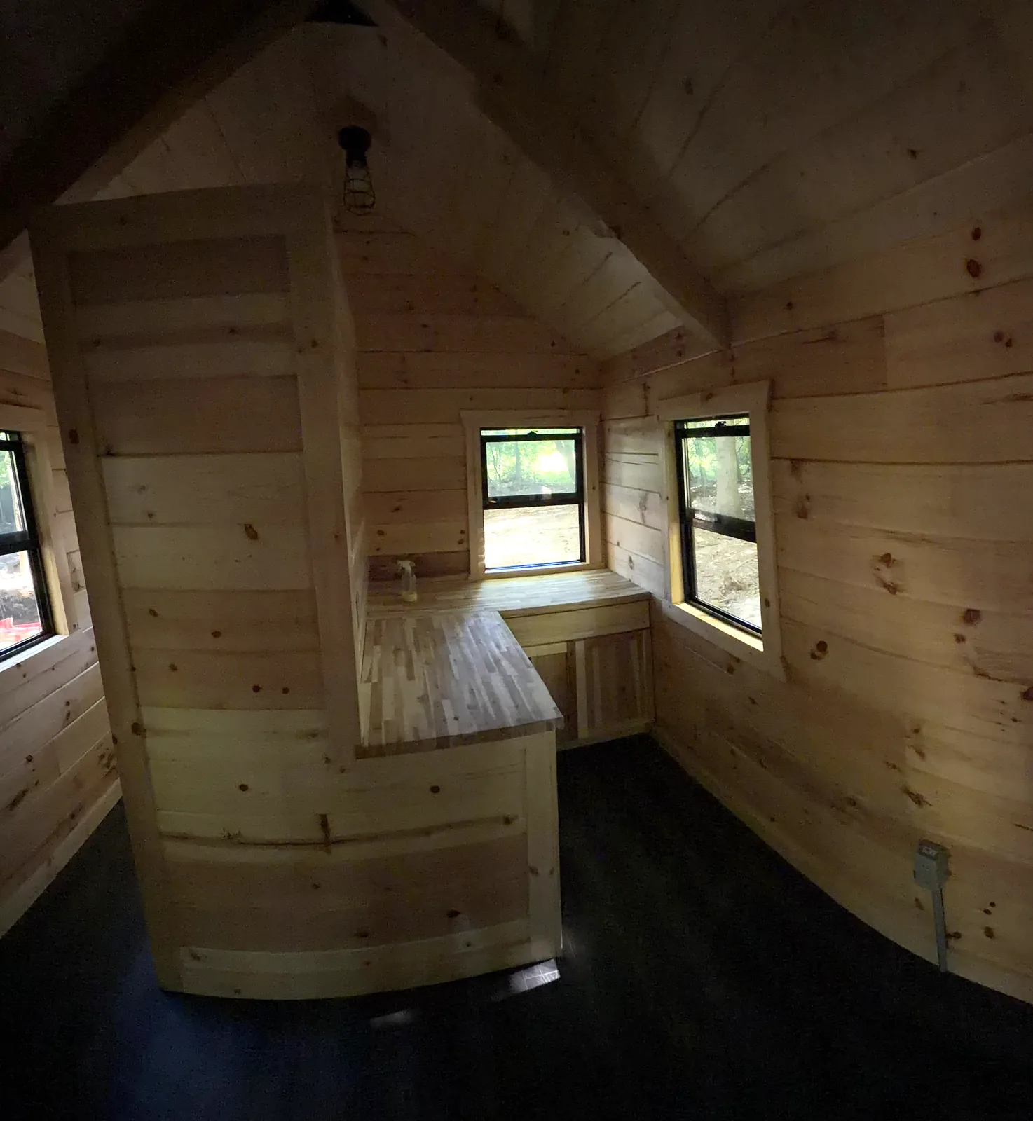 Orana cabin interior with knotty pine walls, vaulted ceiling and butcher-block counter