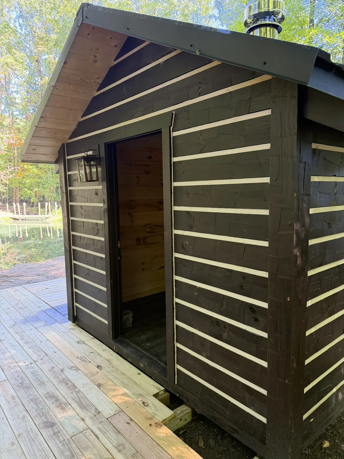 Orana cabin entry and deck beside the pond